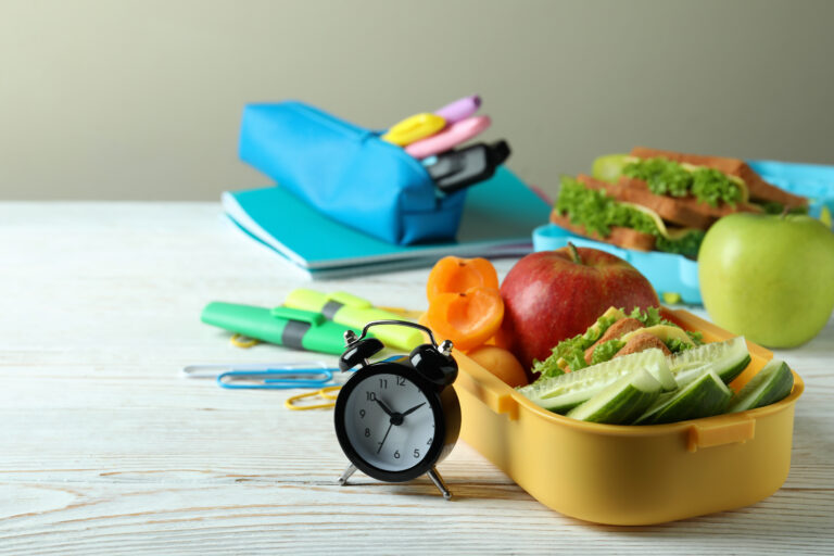 Study concept with lunch boxes on white wooden table